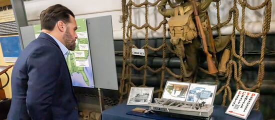 Hendersonville Chamber President/CEO Ashton Jennings inspects a display during a tour of LST-325.