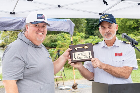 Hendersonville Parks Director accepts a ceremonial bow key from LST-325 Captain John Vaughn.
