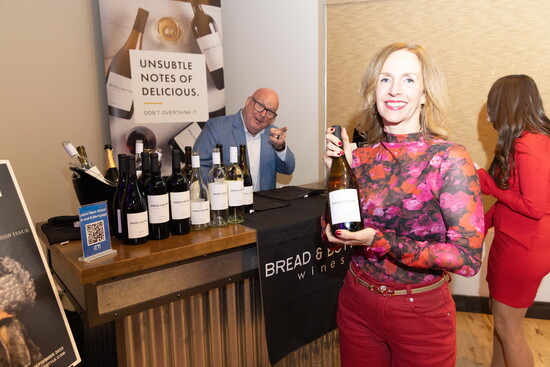 Jim McGreevy in the background giving away a bottle of wine
