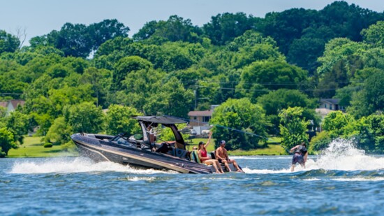 Powerful ski boats pull skiers up and down the lake channel.