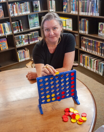 Erika Caputo shows off some of the play areas and games available to kids