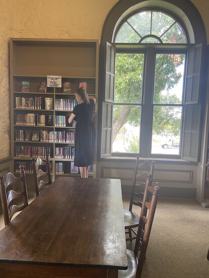 Between bookshelves are beautifully framed windows