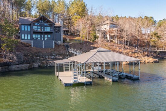 This stunning craftsman home comes with a double-slip boathouse floating on year-round water. 