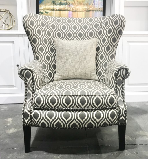 Accessorize a corner with a comfy pattern chair and neutral throw pillow. 