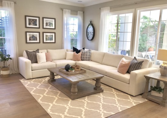 Summer fresh living room with neutral sectional accessorized with patterns of depth and colors that pop.