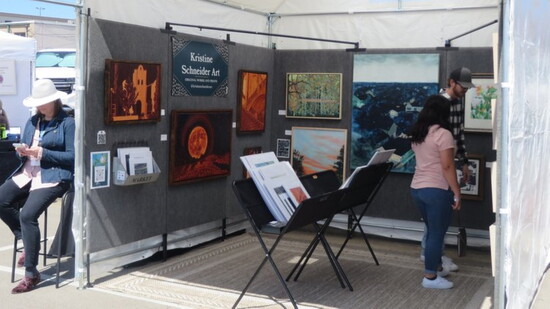 Multiple fine arts vendors fill the streets.