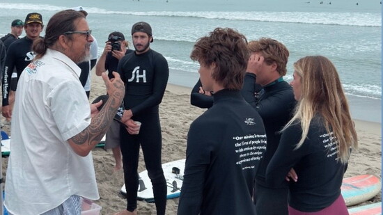 Izzy Paskowitz shares instructions with volunteer surfing instructors at a Surfers Healing camp.