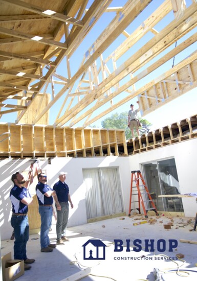 The team observes work at a job site.