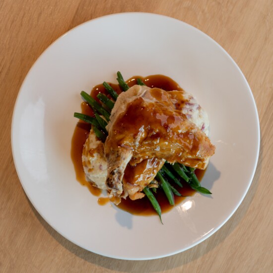Foodcraft's Honey Roasted Chicken served alongside a rustic red mashed potato, haricot verts, and coated in a citrus soy glaze. 