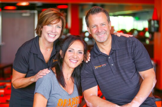 Franchise owner Meghan Littlejohn (L) with her husband Scott and Orangetheory Fitness founder, Ellen Latham