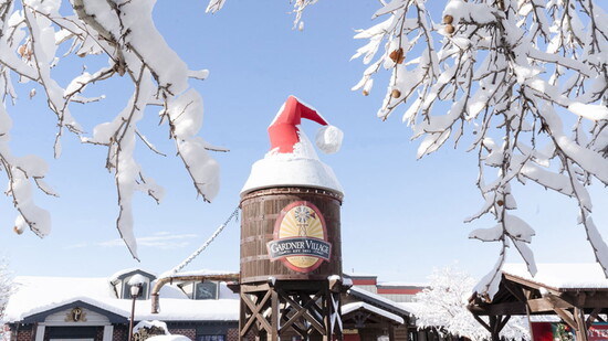 Gardner Village covered in snow and a holiday hat