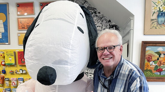 Publisher Scott Davidson with Snoopy at Three Potato Four celebrating Peanuts 75th Anniversary 
