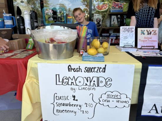 9-year-old Lincoln with his lemonade stand at the event.