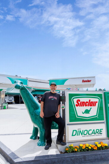 John Fawcett at Sinclair Gas Station with Clair the dinosaur