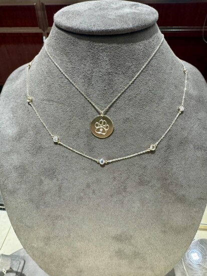 Paw Print Necklace paired with Diamond Bezel Strand Necklace from Victoria Jewelers