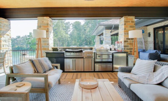 This warm and inviting outdoor kitchen and living space was decorated by Vintage West.