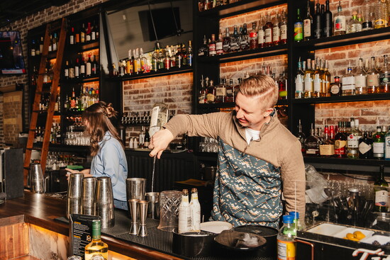 Bartenders crafting signature cocktails for guests. 
