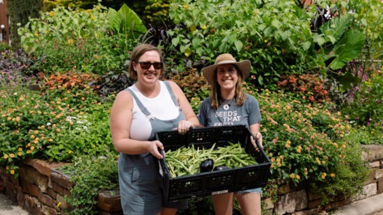 Margaret (left) Alyssa (right) collect food for Seeds that Feed at Fayetteville Farmers Market