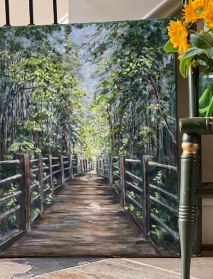 A beautiful painting of a walkway through greenery
