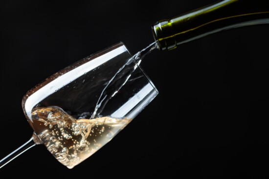 Wine being poured into a glass. 