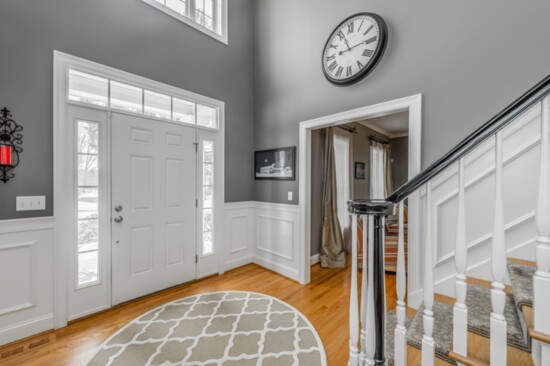 The home features an open, two-story soaring foyer and staircase. 