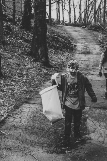 A local child aids in cleanup efforts. Photo by: House on a Hill Photography