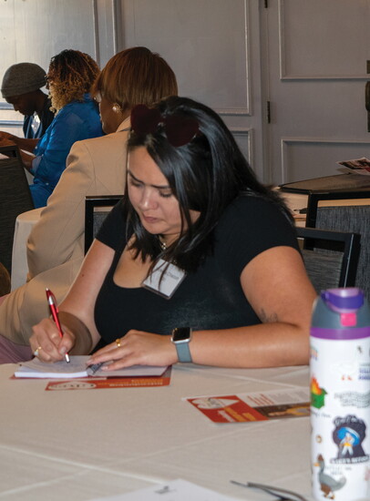 A nonprofit leader vigorously takes notes during a breakout session at the Long Beach Gives Summit on July 17.