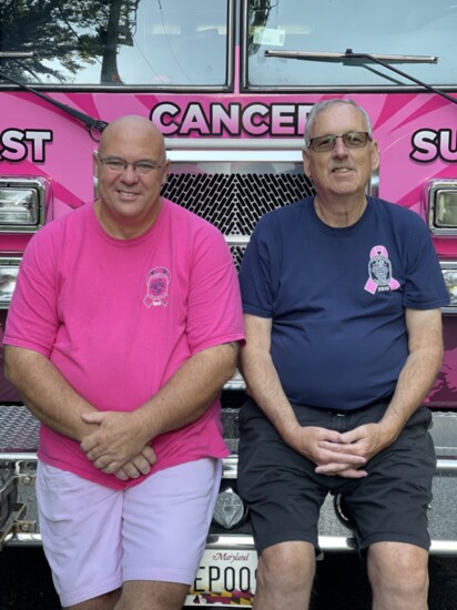 Marshall Moneymaker (in pink) and Pat McTighe drive the pink fire truck known as Vicky. 