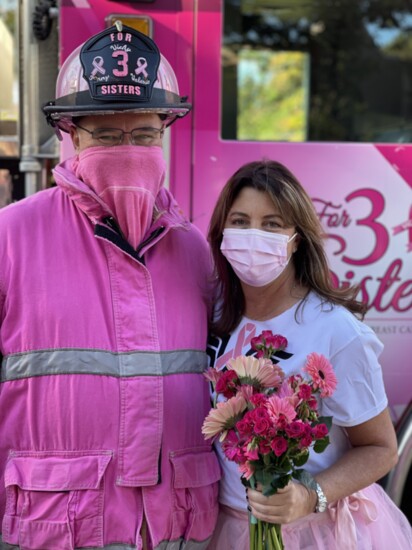 The Pink Fireman Marshall Moneymaker of For 3 Sisters greets a cancer survivor. More at F3S.org.