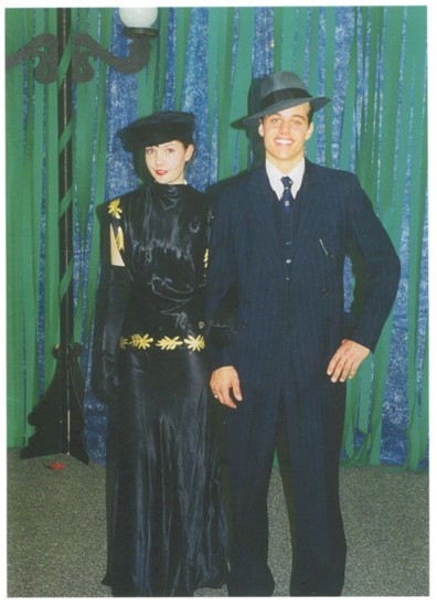 Formal event with models wearing a 1939 Satin Evening Gown and suit and tie belonging to my parents