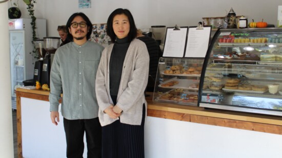 Do Kim and Hanna Park stand next to the pastry counter inside their Raonjena coffee shop