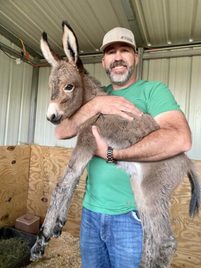 Celina resident Keith Preston holds his newly adopted donkey "Millie."