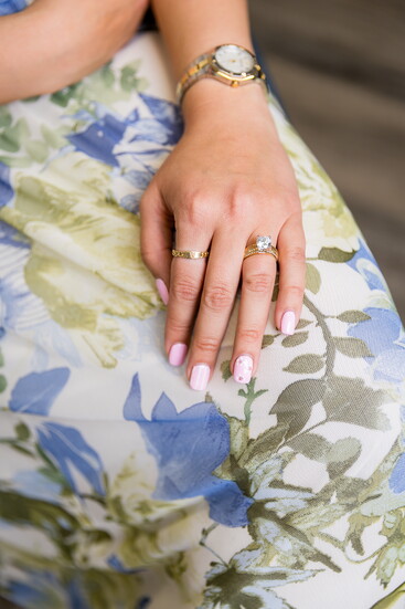Modern cigar-style solitaire diamond ring featuring a textured band design. Modeled by Emilee Bozarth.