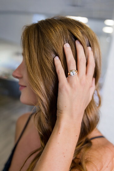 Hidden halo and sideways oval setting create a contemporary look, paired with a curved matching band. Modeled by Delaney Spencer.