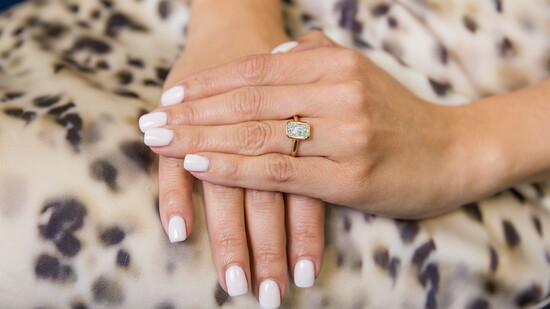 A radiant-cut diamond ring showcasing a classic bridal design. Modeled by Sierra Broschart.