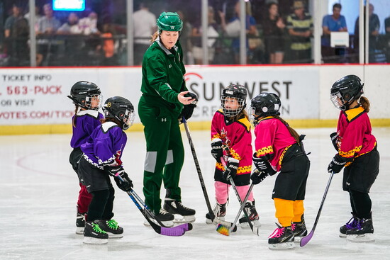 Olympian and coach Lyndsey Fry with Small Frys players, helping girls ages 6–12 discover hockey and build confidence both on and off the ice.
