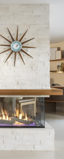 A remodeled corner fireplace creates a modern focal point with updated style and warmth.