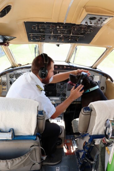 Co-pilot Romeo preparing for take off with his owner Greg Haman of Agape Flights. Photo by Abby Duncan.