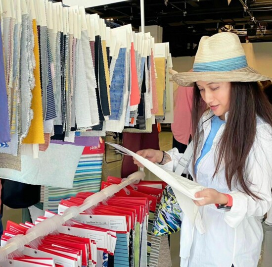 Yang examines fabric samples.