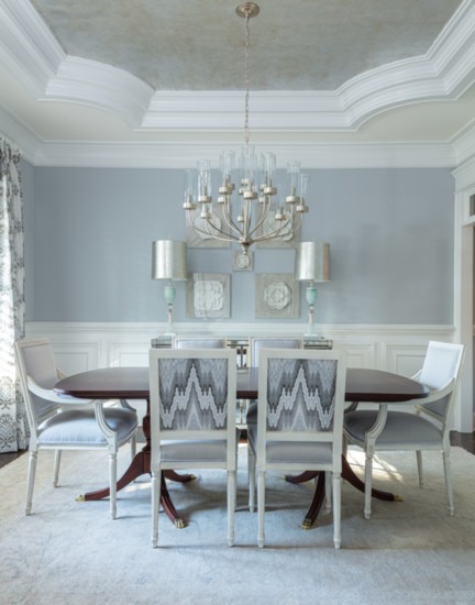 Host holiday meals underneath a chandelier which reflects the trey ceiling inset with mother-of-pearl finish. 