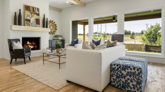 The decor in this staged home accentuates beautiful wood floors and beams. Photo: Vast Media.