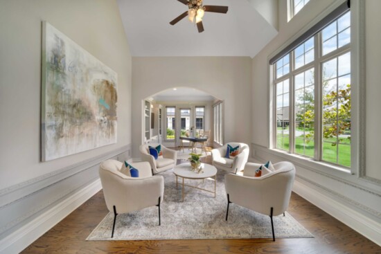 A large painting mimics the colors seen outside large windows. Photo: Green Country Real Estate Photography.
