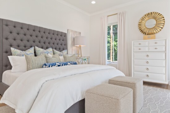 A lush bed and throw pillows make this bedroom cozy. Photo: Green Country Real Estate Photography.