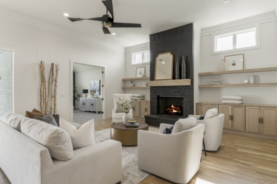 The staging in this home showcases a tall fireplace. Photo: Vast Media.