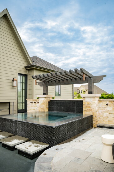 Black basalt, Ripson tile and flowing water transform this custom spa into a tranquil escape designed to engage the senses.