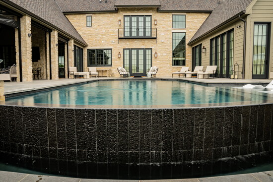 Visible from nearly every room in the home, the infinity-edge pool serves as the centerpiece of this thoughtfully designed courtyard retreat.