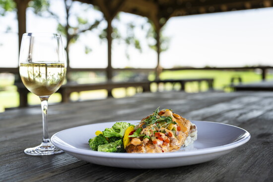 Relish in delicious comfort-style food with peaceful golf-course views and a crisp glass of wine for an evening out.