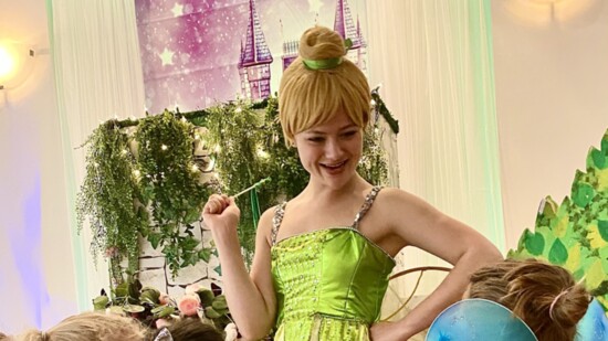 Acting Tinker Bell character delights little girls with her magic.