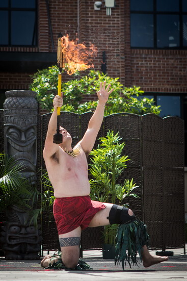 A performer twirls a fire baton. 