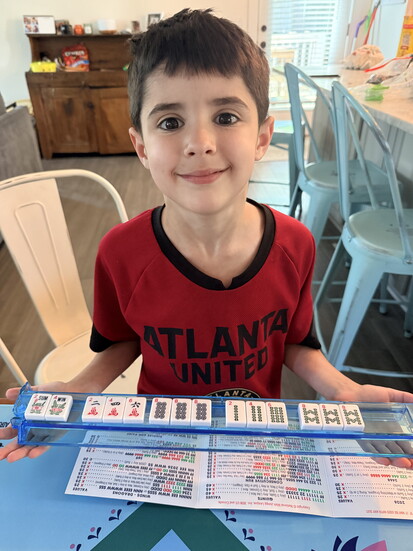 Lucas Weil, 8, playing mahjong at home.